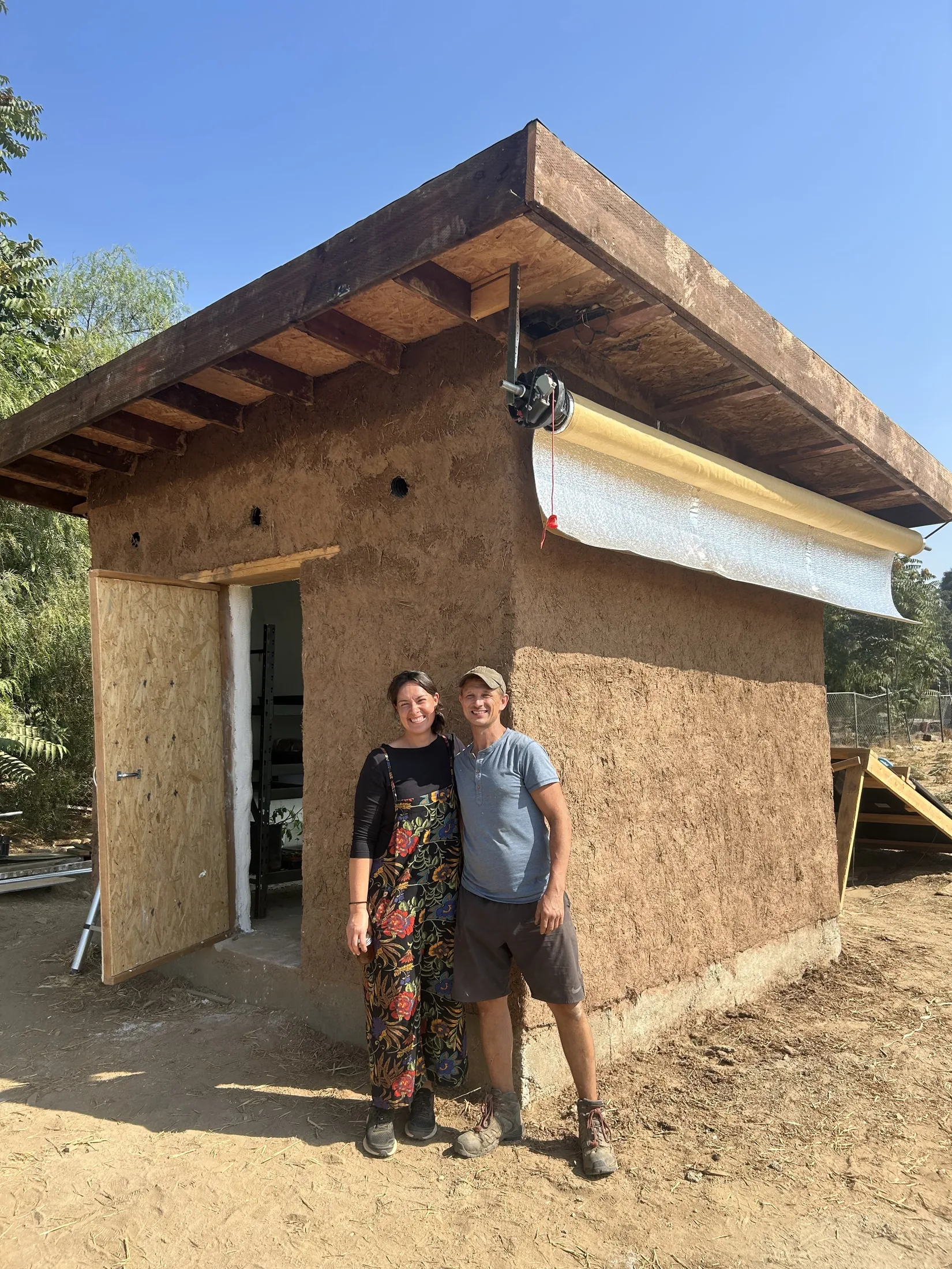 From The Land founders standing in front of a Littlest Big Farm