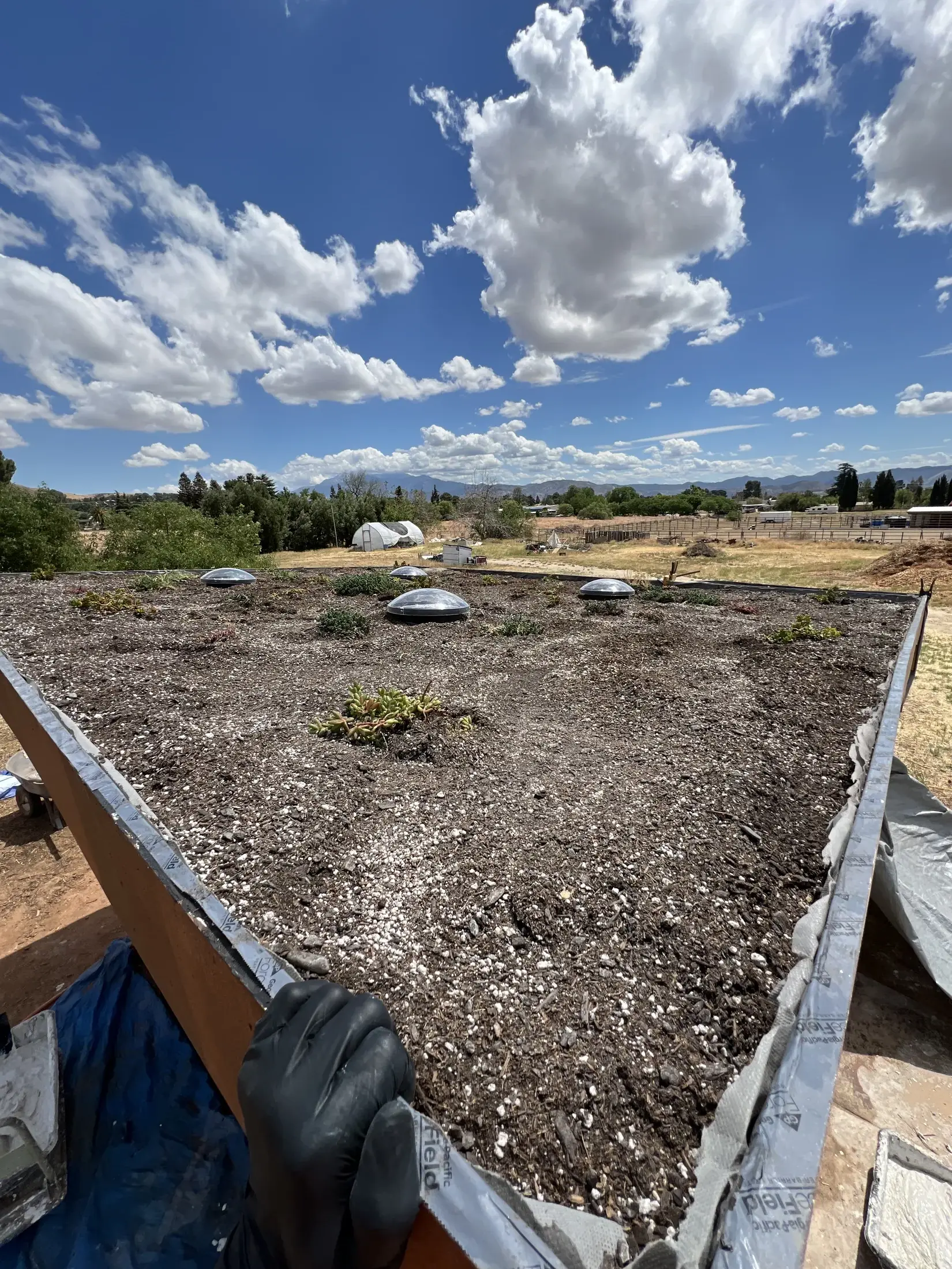 Littlest Big Farm roof and daylight tubes under a blue sky